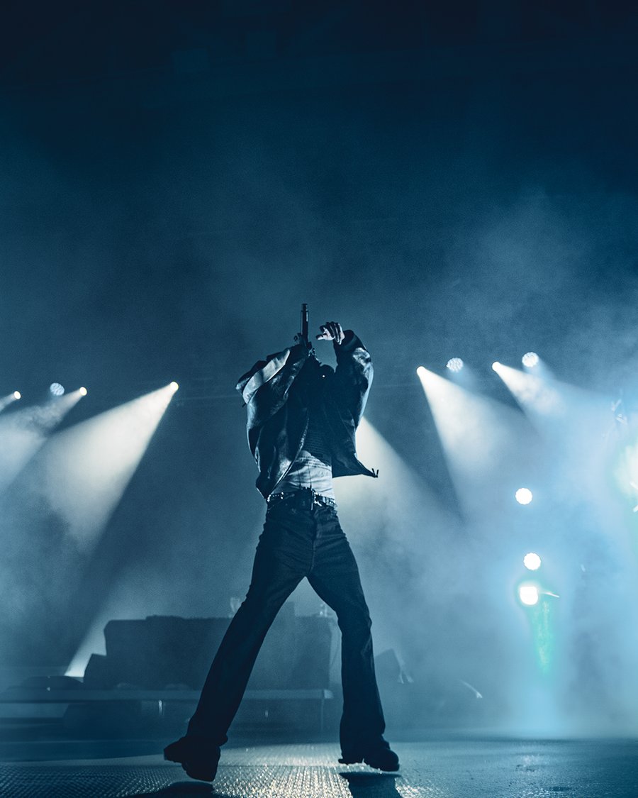 Lil Tecca performing under blue stage lights, Durham, NH