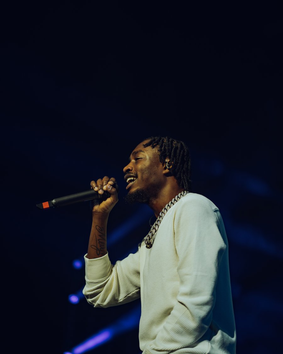 Lil Tjay performing on the mic