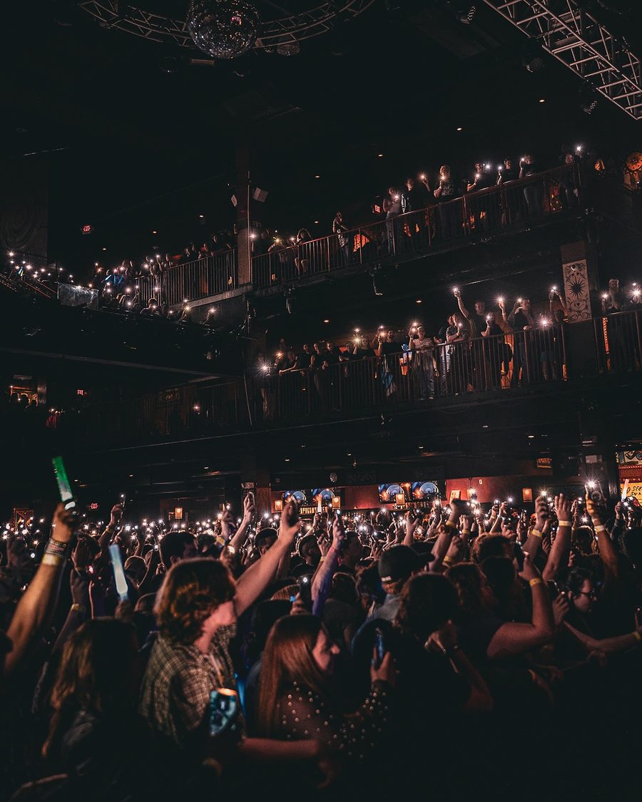 Fans lighting up three balconies with phone lights at a Saint Motel show, Boston, MA